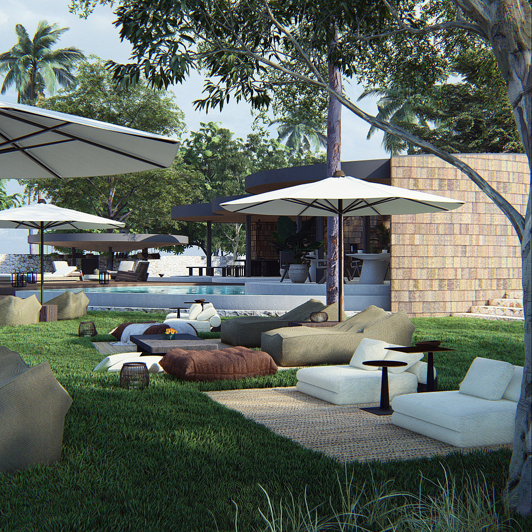 View of graden sun bathing area at uluwatu hotel with outdoor furniture on the ground and garden umbrellas