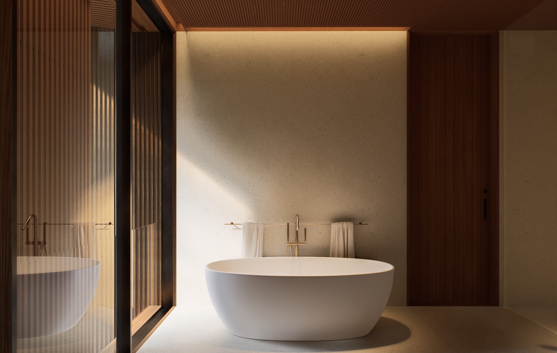 Close up view of the master bathroom bathtub with brushed gold sanitary ware and large window openings