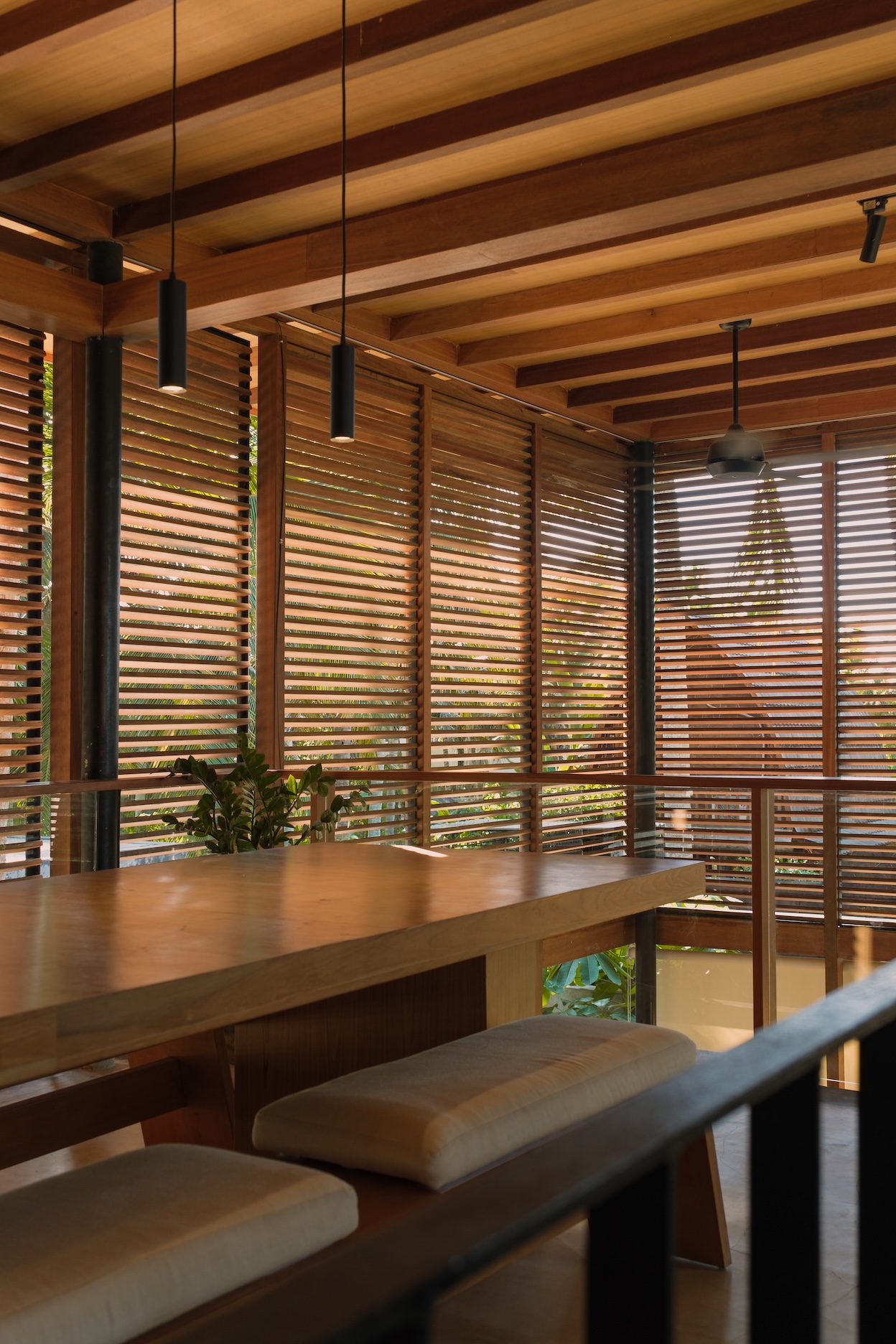 1st villa dining room space showing wooden table and wooden screens surrounding the space