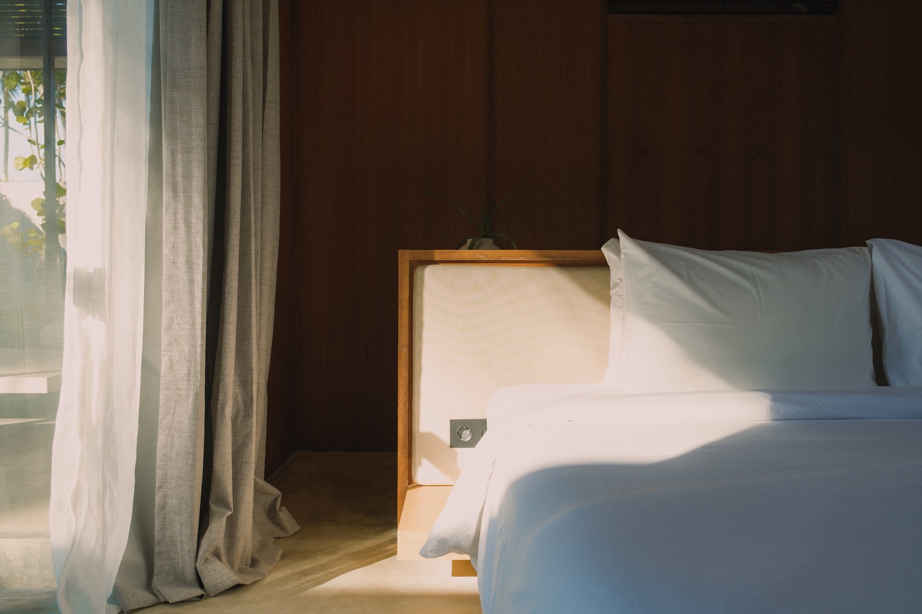 Typical bedroom view at rumah amadangi with padded bed head and free standing bed frame