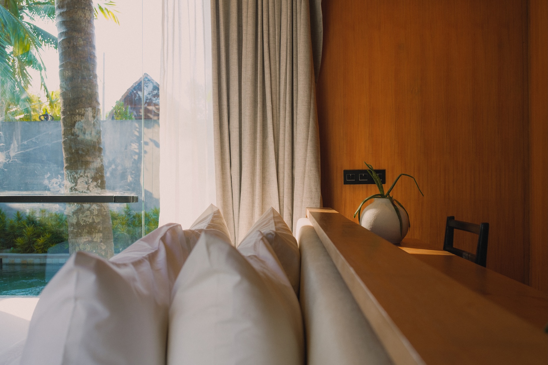 Typical bedroom view at rumah amadangi with padded bed head, free standing bed frame, and desk