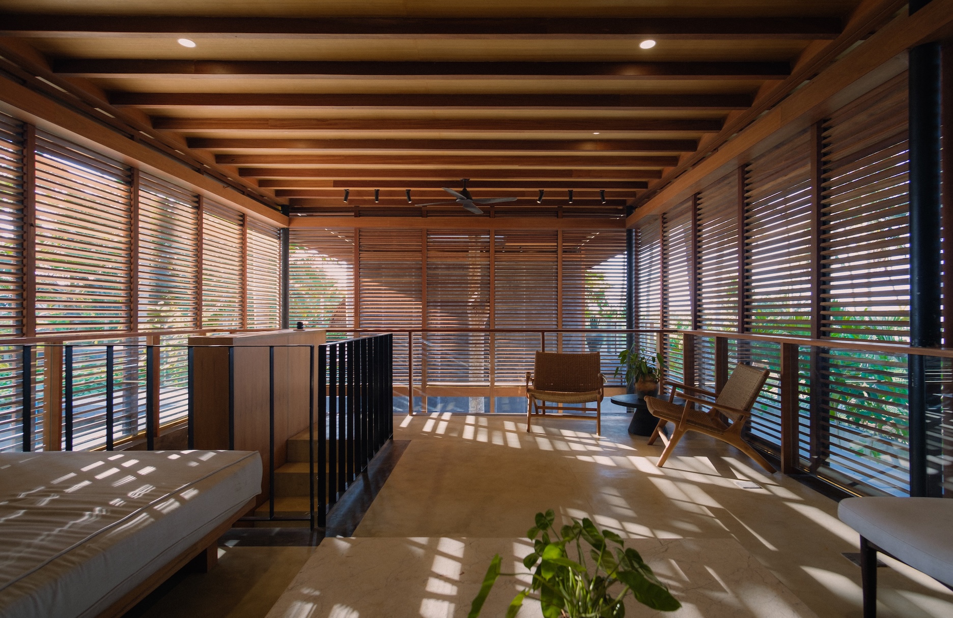 2nd villa living room view showing light play from the wooden screens