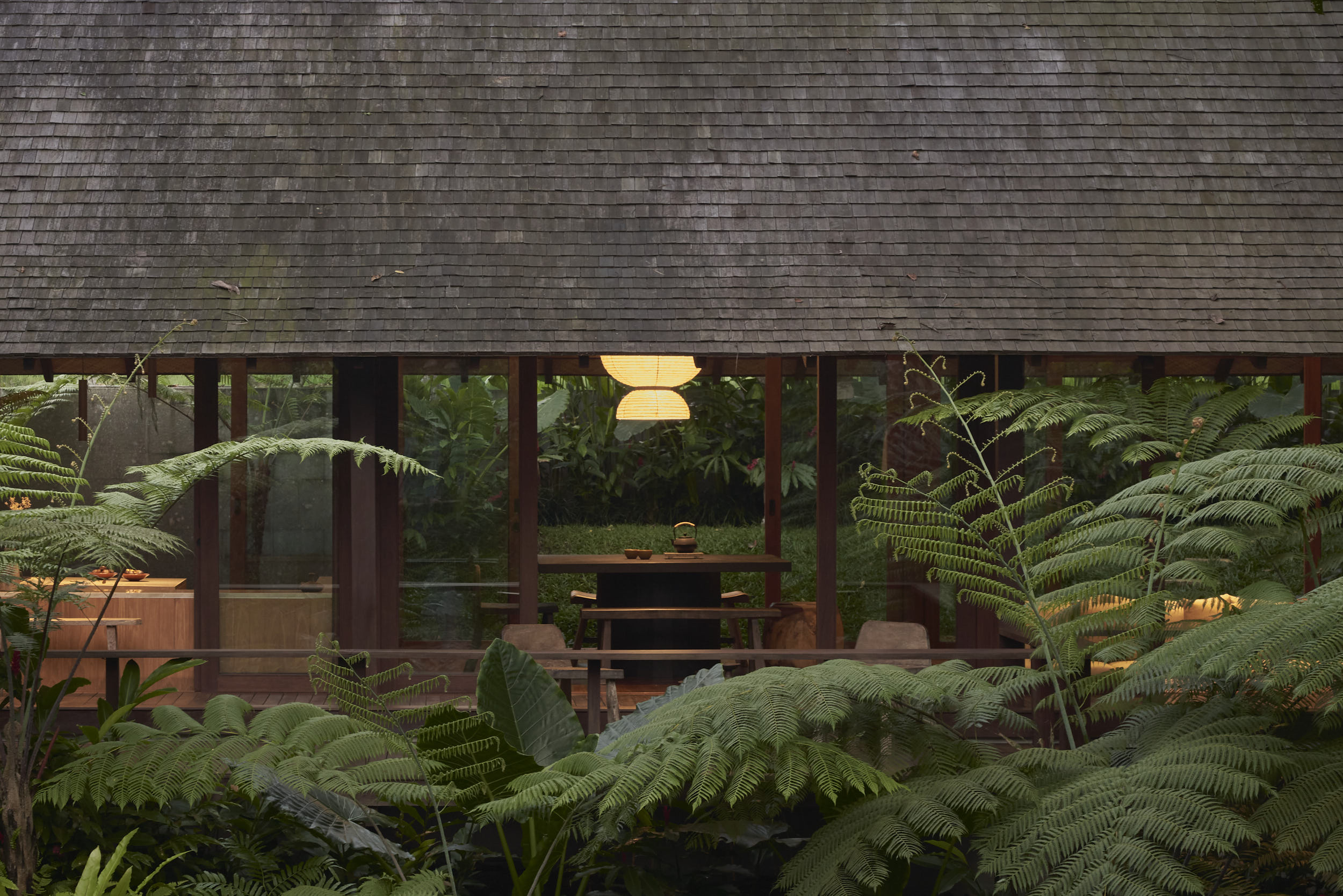 Dining Room view of Rumah Haruku from the forest looking into the house