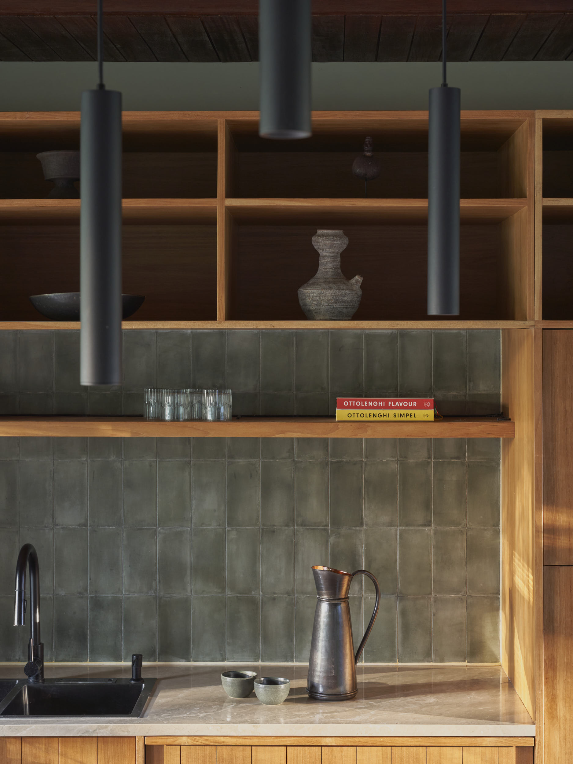 Detailed view of the kitchen showing local cement tiles and wooden cabinetry