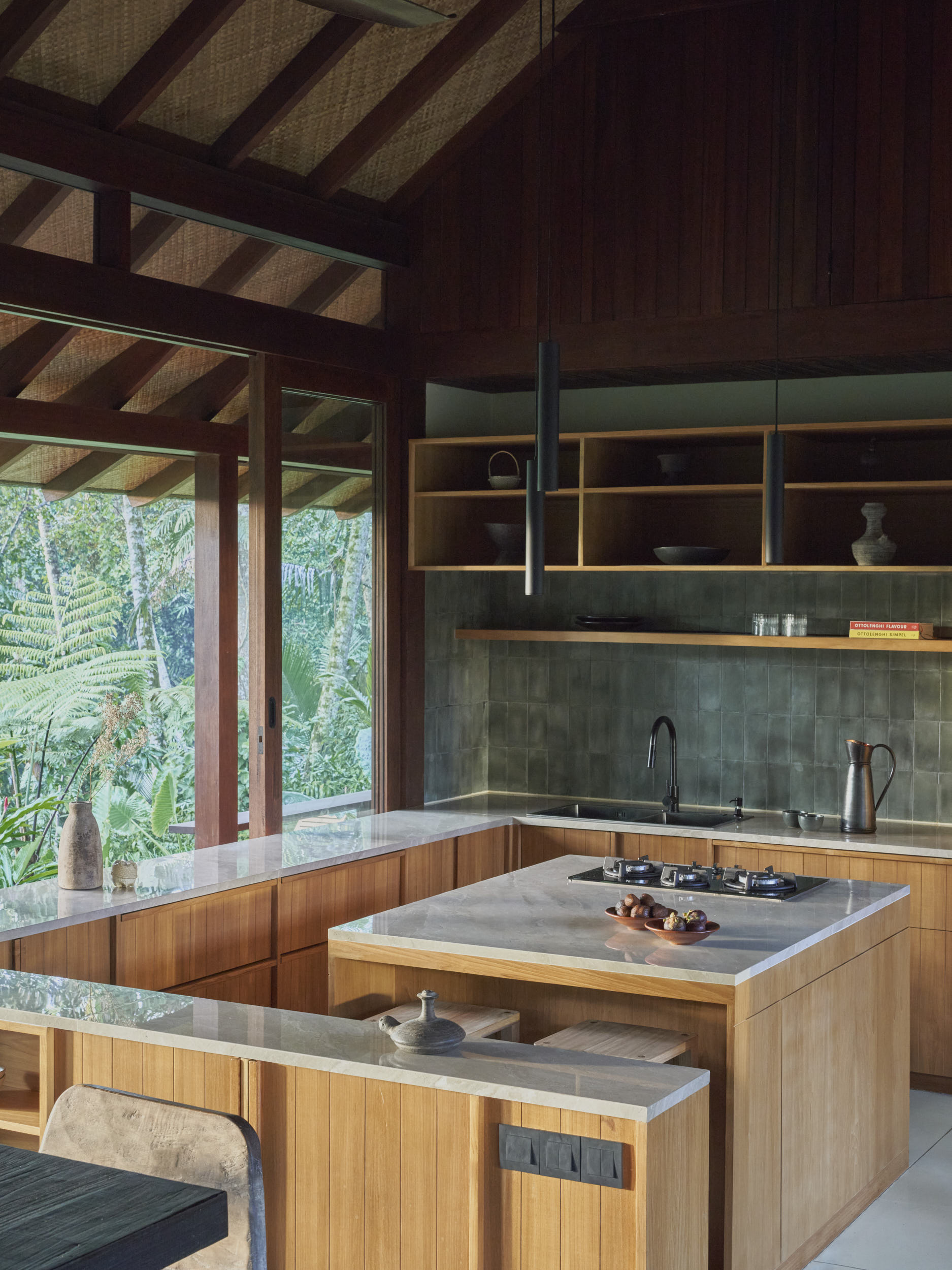 Kitchen space of the house with large windows looking towards the surrounding landscape