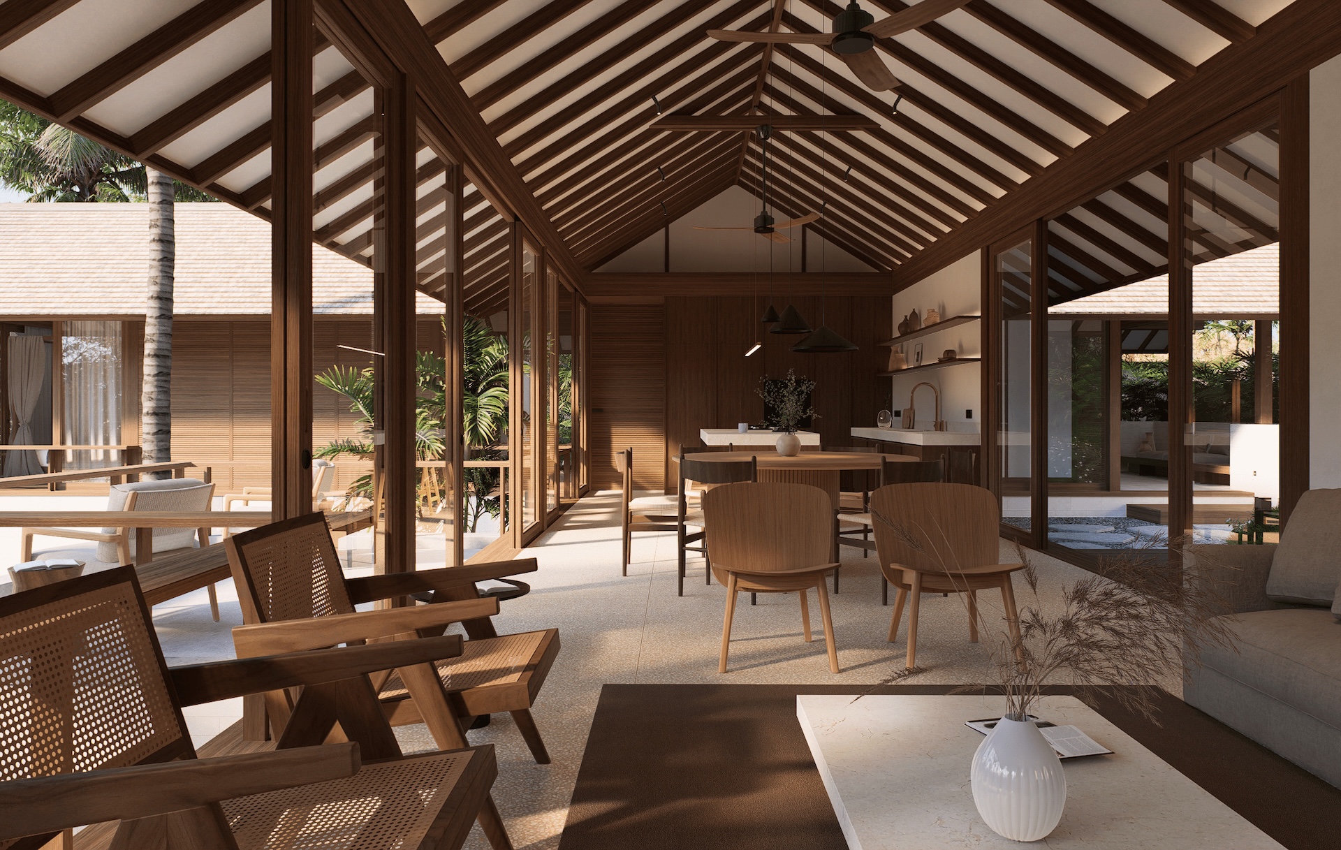 View of the great room looking from the living room towards the kitchen space showing the continuity of the wooden roof structure, terrazzo flooring, and white paneled walls