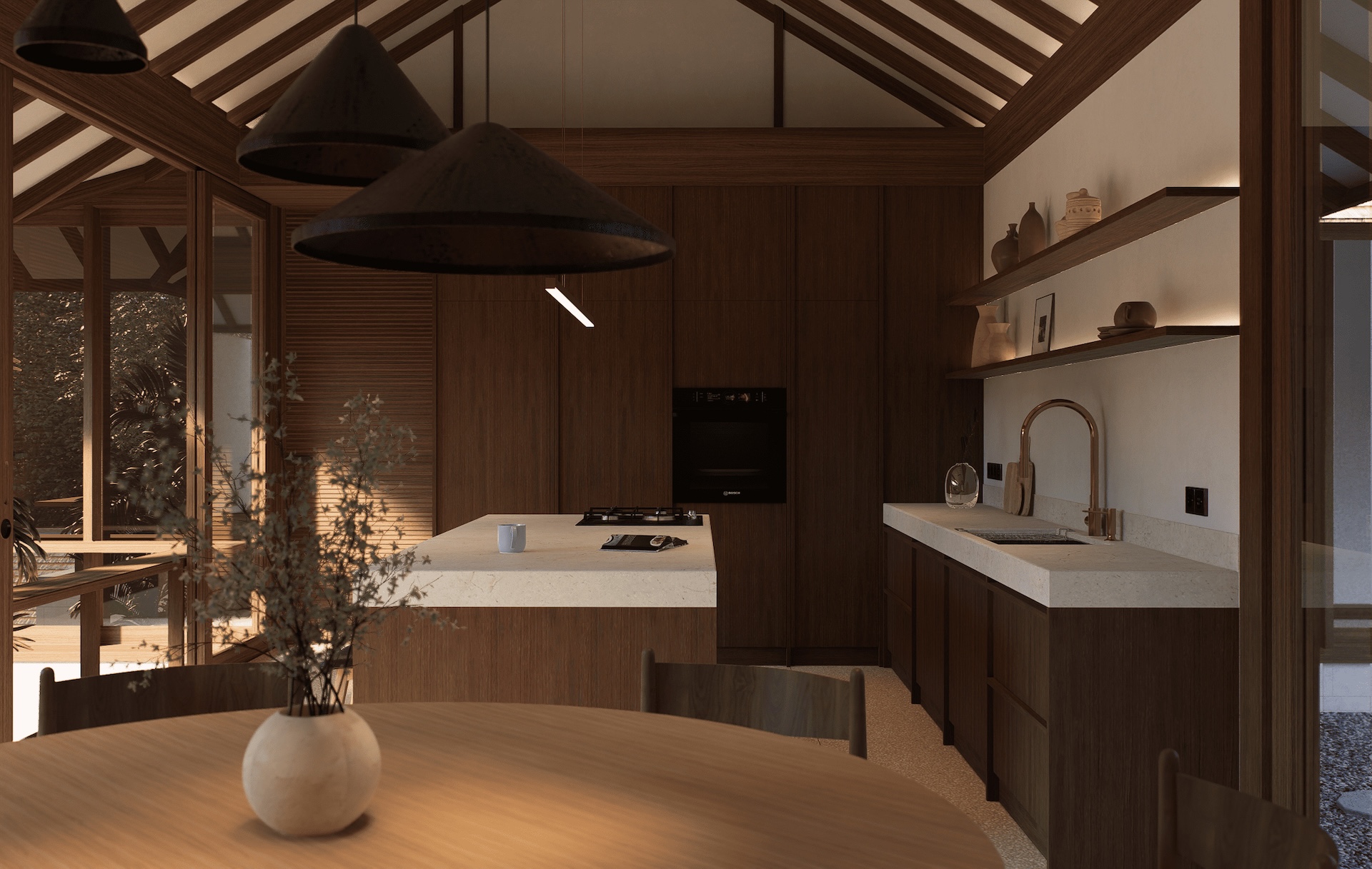 View of kitchen space from dining table showing local marble tops, hanging shelves, built in appliances, and brushed gold kitchen tap