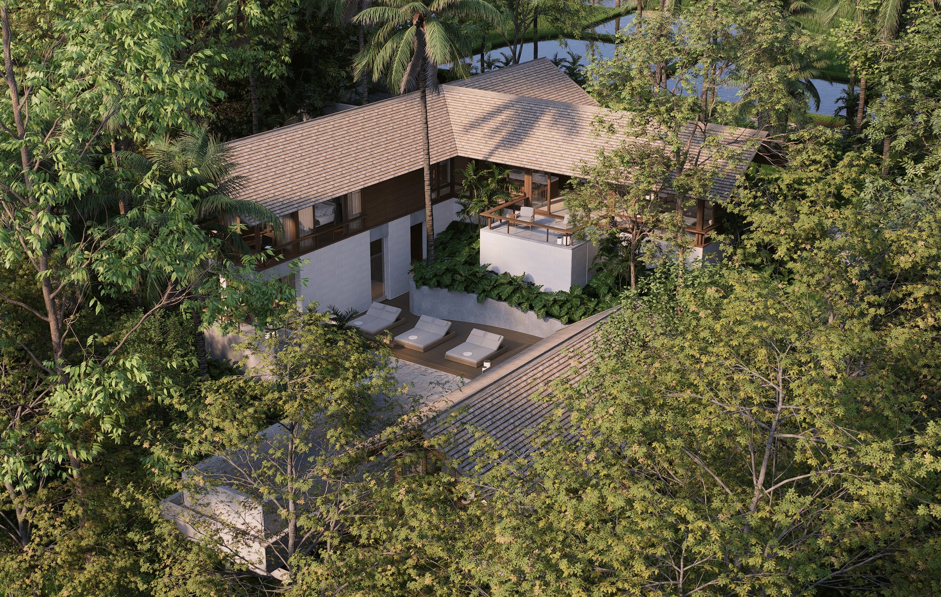 Aerial view of rumah umadawa showing the mass of the building and surrounding landscape including rice paddies and mature trees