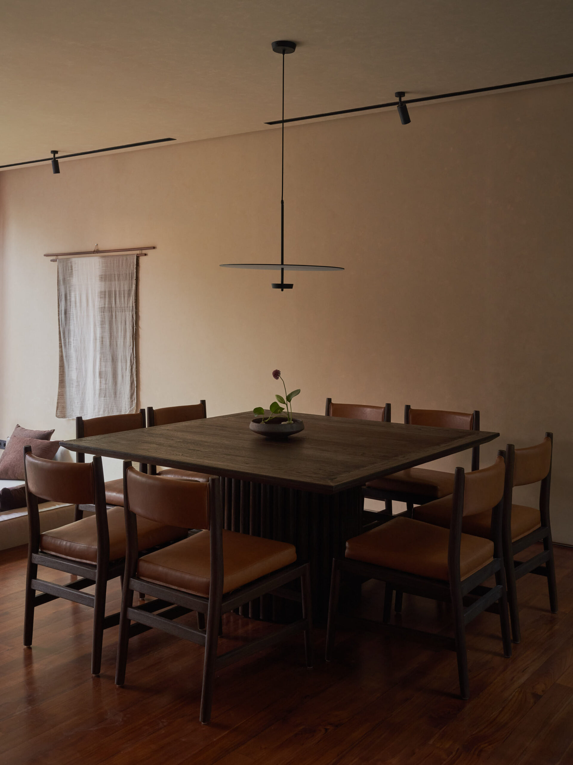 Dining room at leaf berawa showing rectangular table with 8 leather upholstered dining chairs