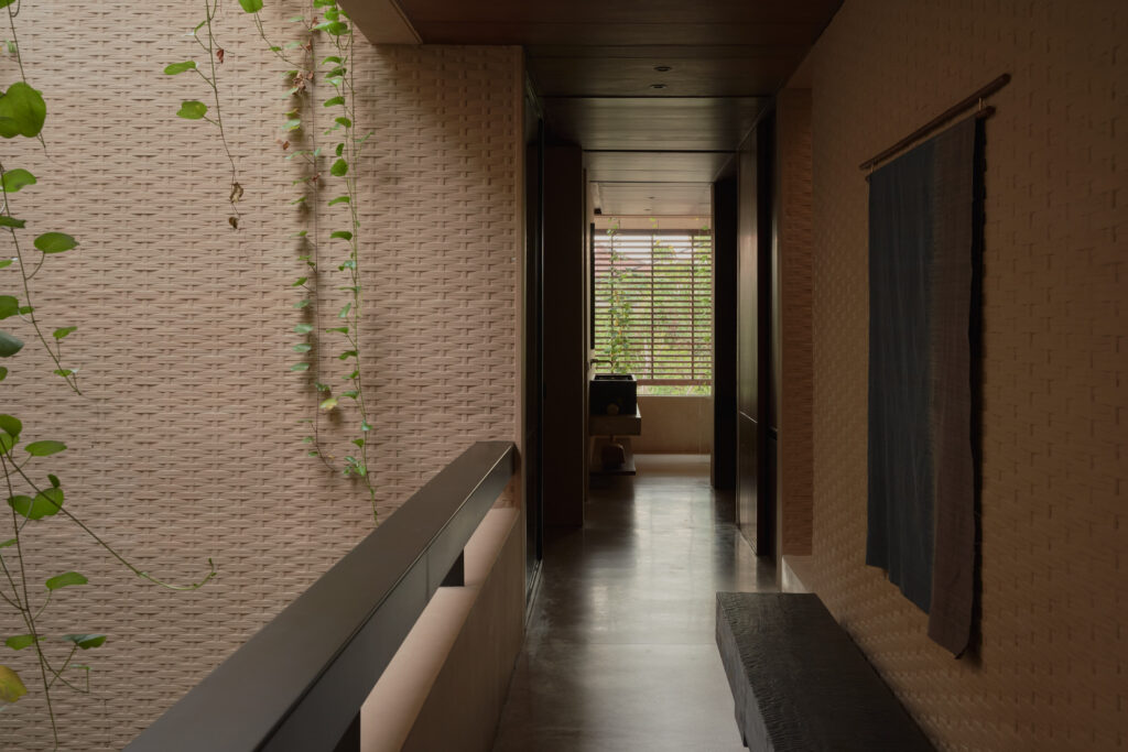 1st floor corridor connecting the bedrooms seeing through the master bathroom to the exterior facade wooden screens