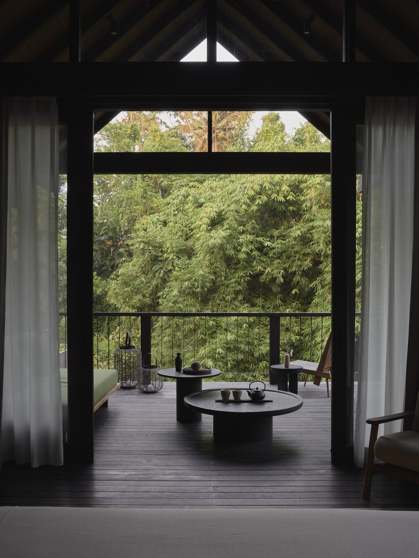 View from inside a bedroom pavilion looking out through the window overlooking the terrace