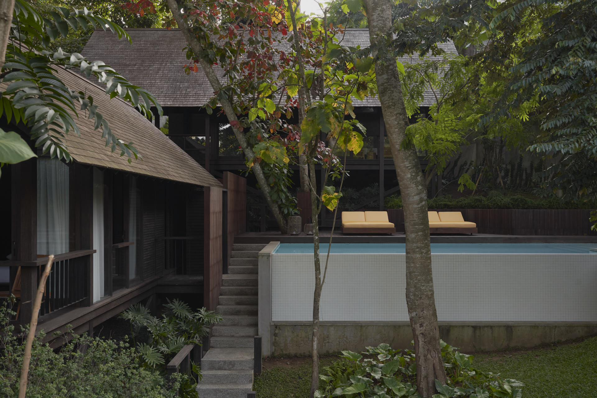 Overview of pool, a bedroom pavilion and main pavilion of rumah lituhayu